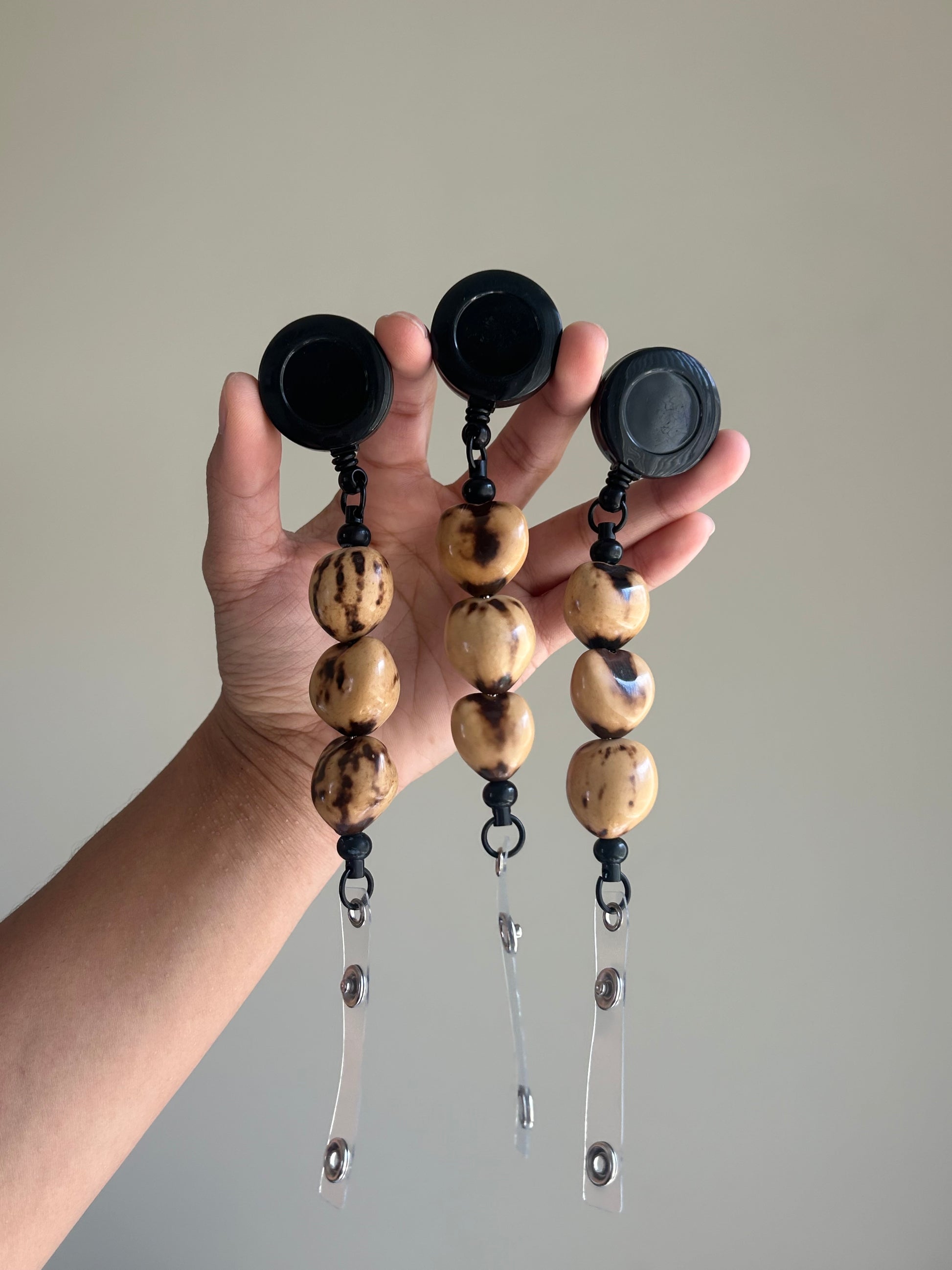 Marble brown kukui nut badge reel with retractable ID badge