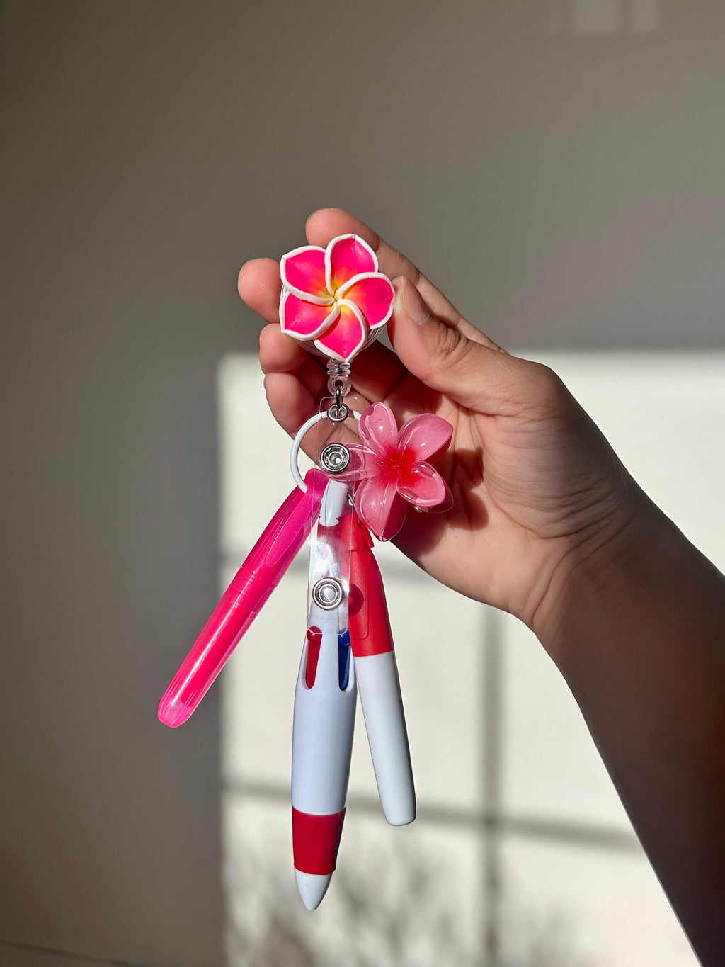 Pink plumeria floral badge reel with retractable clip and pen set 