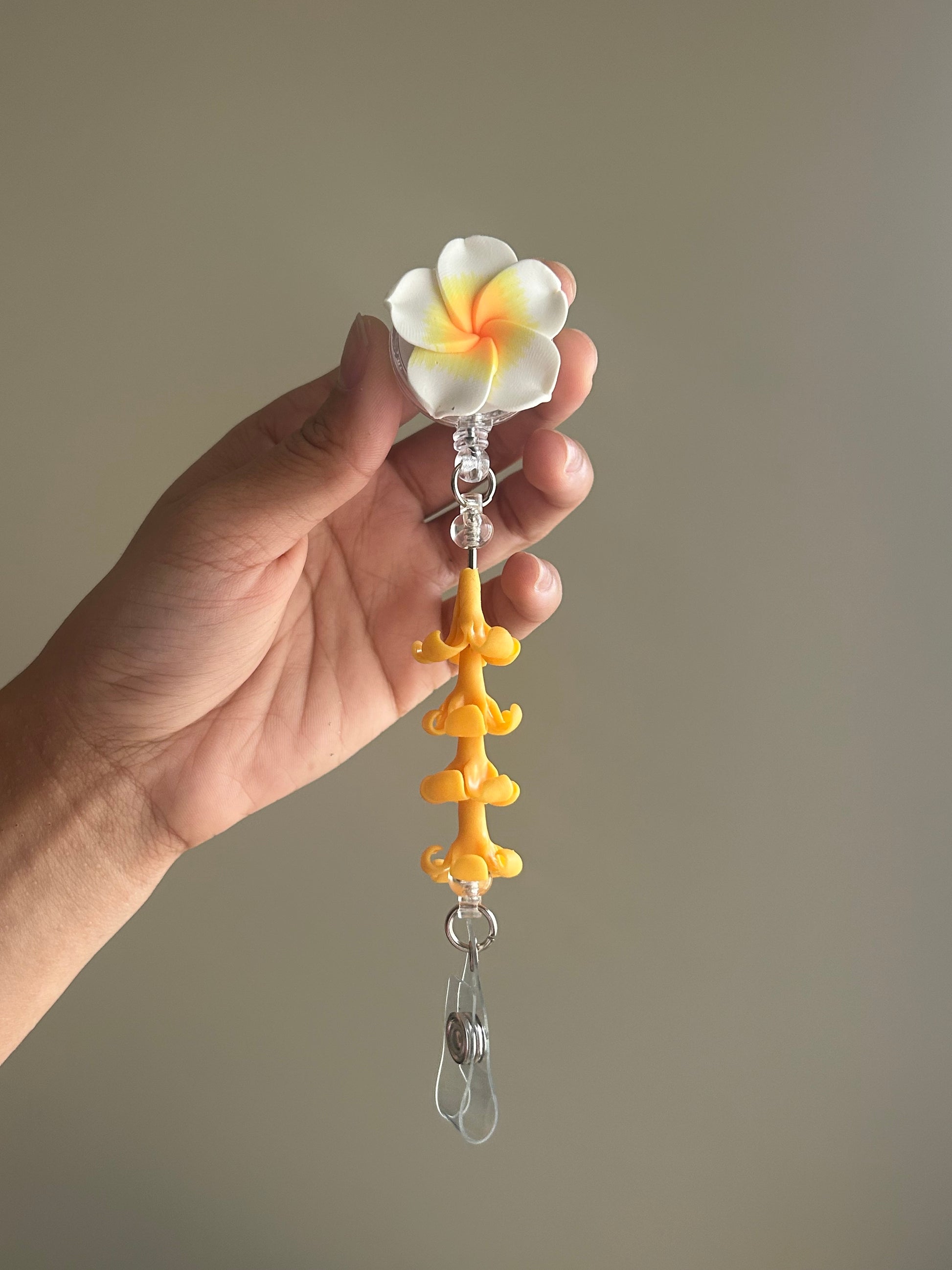 Plumeria and puakenikeni floral badge reel with retractable clip