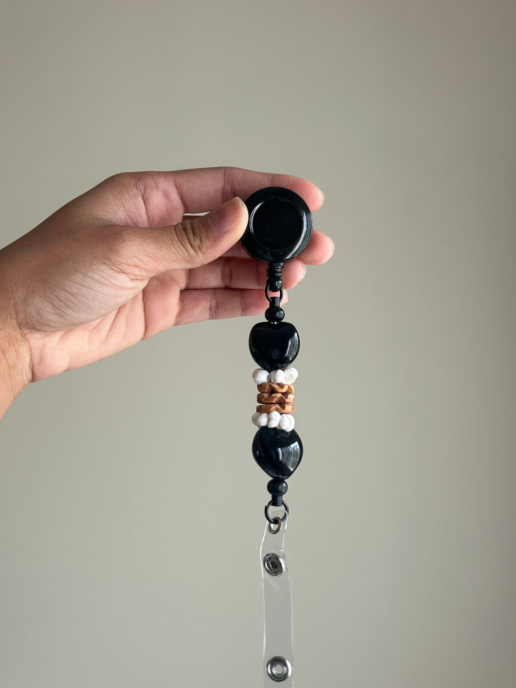 Black kukui nut badge reel with retractable clip