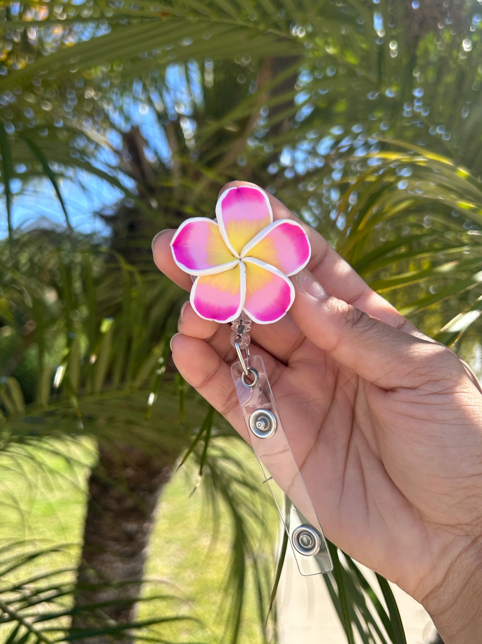 Plumeria floral badge reel with retractable clip