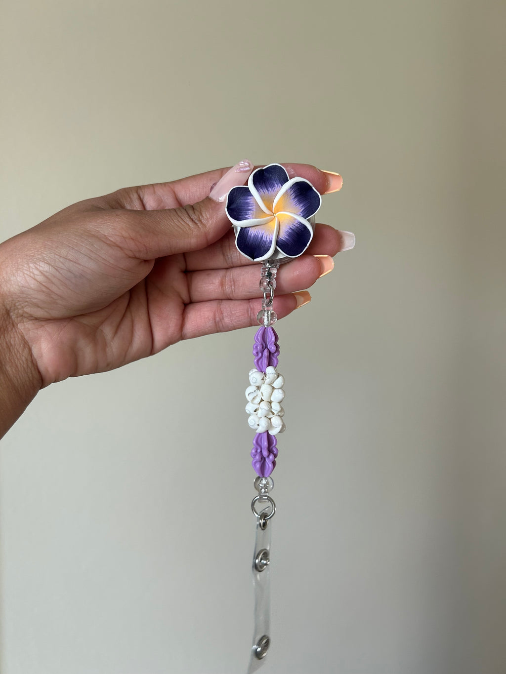 Purple crown flower plumeria badge reel ID holder with retractable clip
